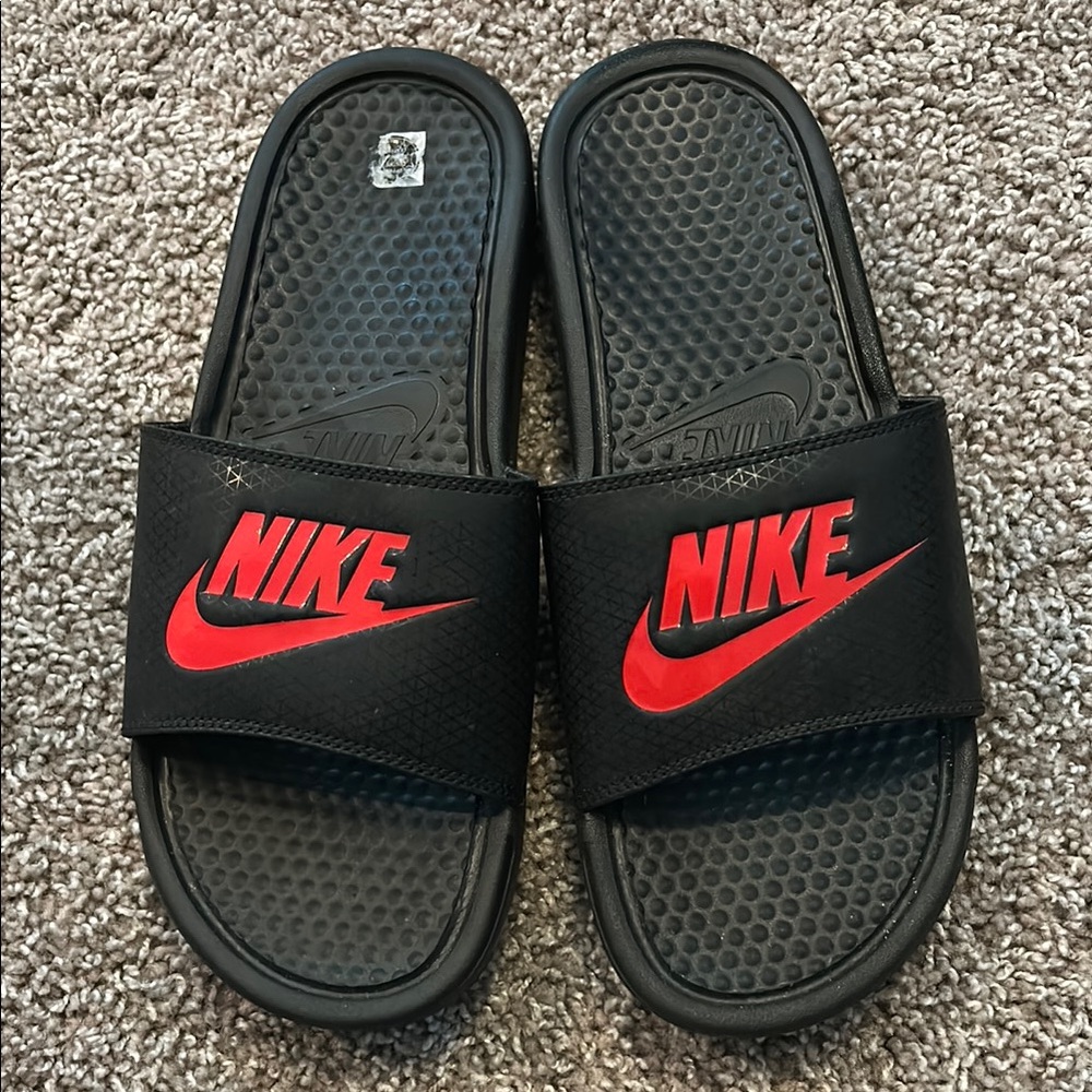 Black and red NIKE slides